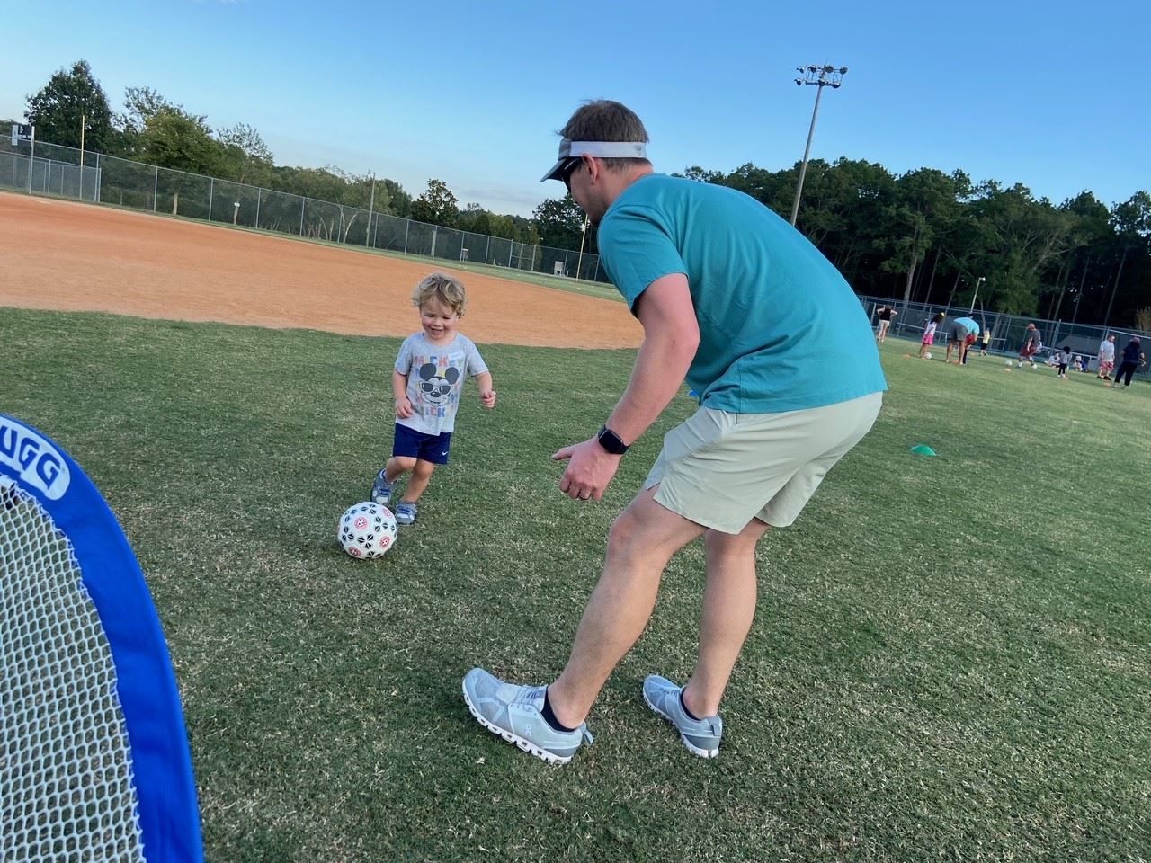 young boy kicking soccer ball 