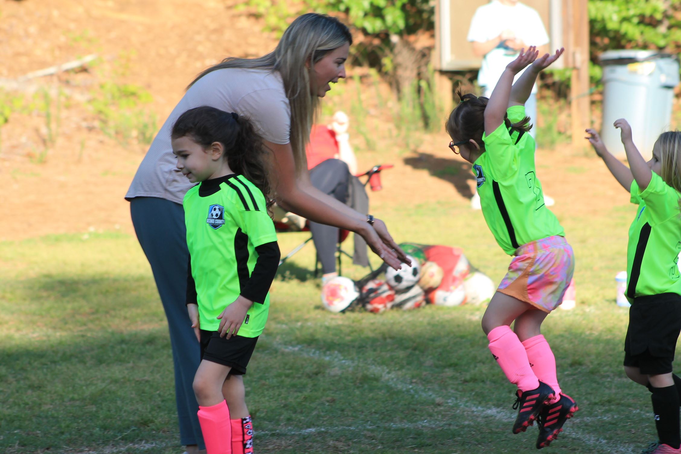 Soccer coach high fiving with players 