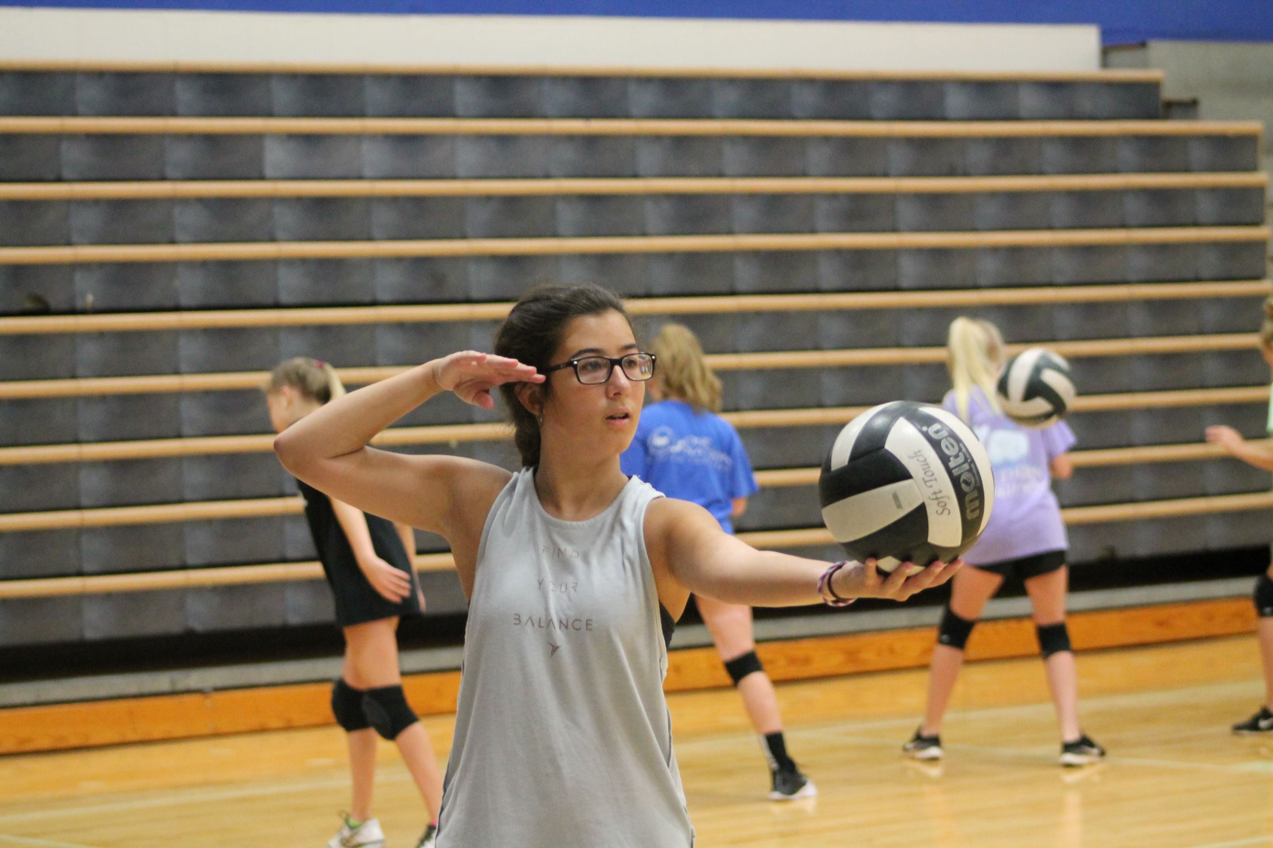 Girl set up to serve volleyball