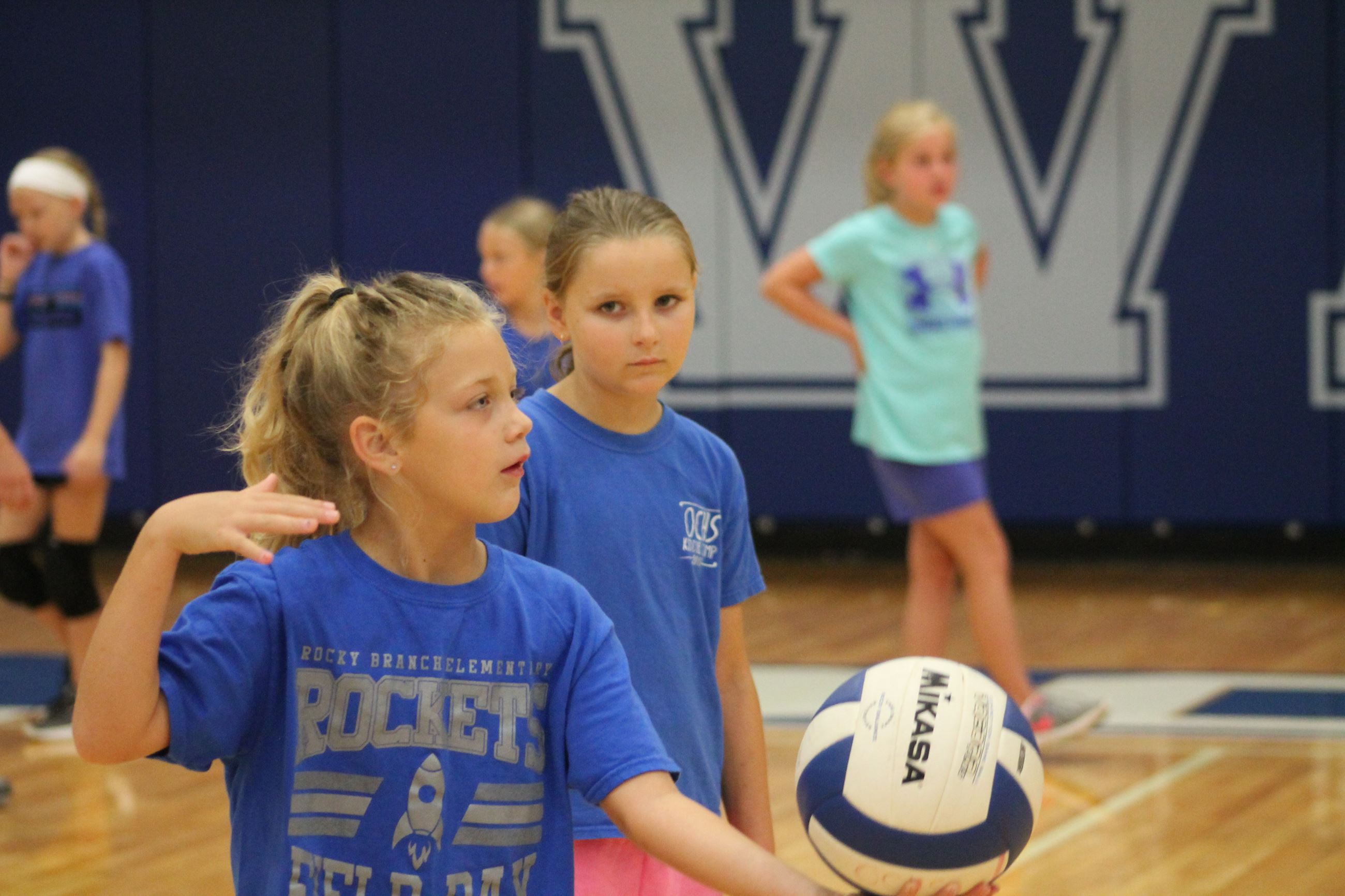 Girl setting up to serve volleyball